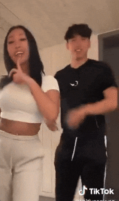 a man and a woman are dancing in a tiktok video .