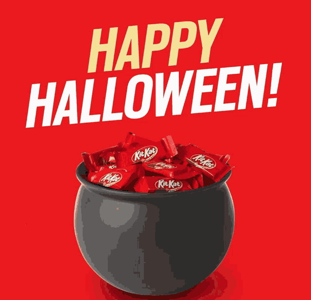 a black cauldron filled with kitkat candy with the words happy halloween above it
