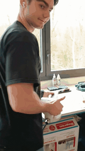 a man is pointing at a box that says depron on it