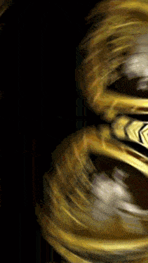 a blurred image of a gold object with an arrow pointing to the right