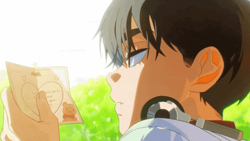 a boy holding a piece of paper with a heart on it that says " i love you "