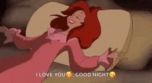ariel from the little mermaid is laying on a bed with her arms outstretched and a good night message .