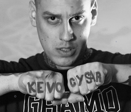 a man with a tattoo on his fist that says kevo gysr