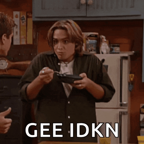a man in a kitchen with the word gee idkn on the bottom right