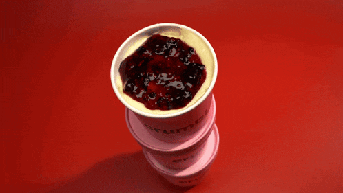a pink cup that says crumbs on it