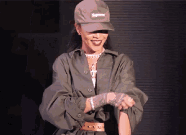 a woman wearing a hat that says supreme is smiling