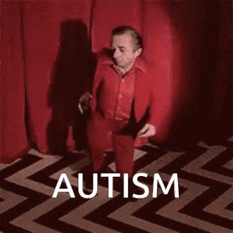 a man in a red suit is dancing on a black and white chevron rug .