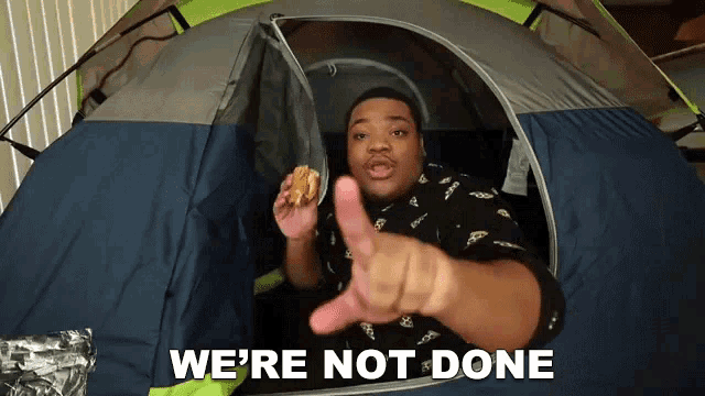 a man in a tent with the words we 're not done written on it
