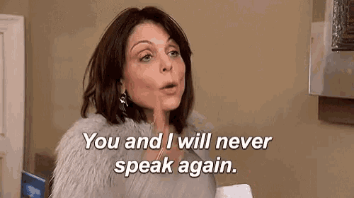 a woman in a fur coat is holding her finger to her mouth and saying `` you and i will never speak again . ''