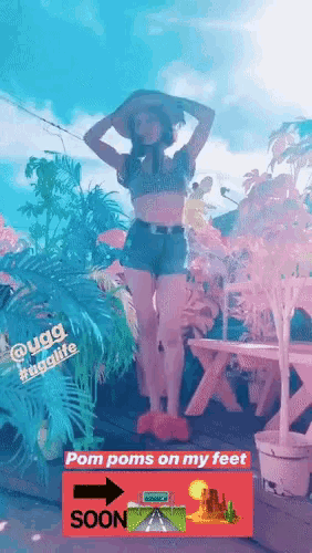 a woman wearing shorts and a hat stands in front of a sign that says " pom poms on my feet soon "