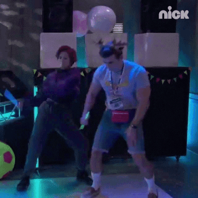 a man and a woman are dancing together on a dance floor in a room .