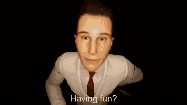 a man in a white suit and red tie is holding a syringe .