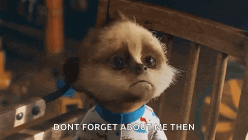 a cartoon meerkat is sitting in a chair and saying " dont forget about me then " .