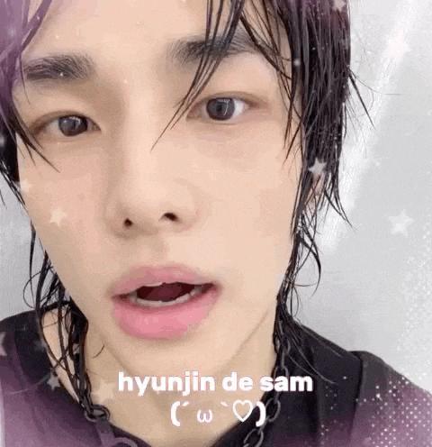 a close up of a person 's face with the words `` hyunjin de sam '' on it .