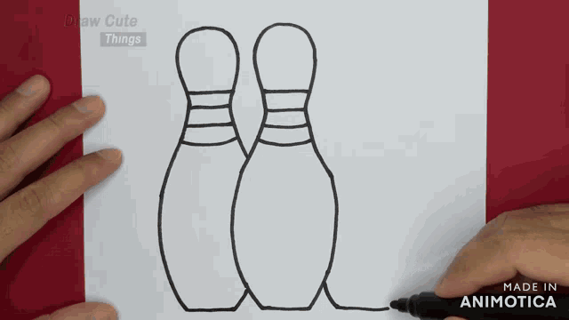 a person is drawing a bowling pin with a black marker