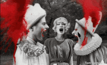 a black and white photo of two clowns and a woman with blood coming out of their mouths by tom slemen