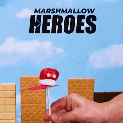 a person is holding a red marshmallow on a stick with the words marshmallow heroes written above it