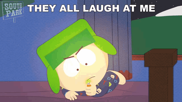 a cartoon character from south park laying on a bed with the words they all laugh at me above him