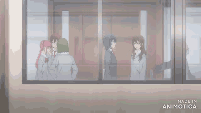 a group of people are standing in front of a window with the words made in animotica below them