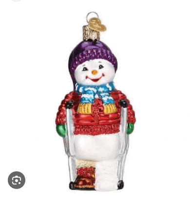a christmas ornament of a snowman wearing a purple hat and scarf