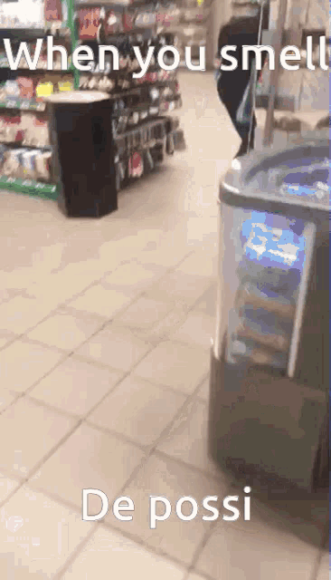 when you smell de possi is written on a tiled floor in a store