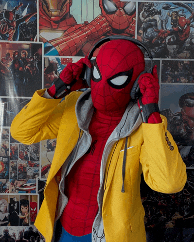 a man in a spiderman costume is listening to music with headphones
