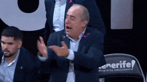 a man in a suit is sitting in front of a chair that says tenerife