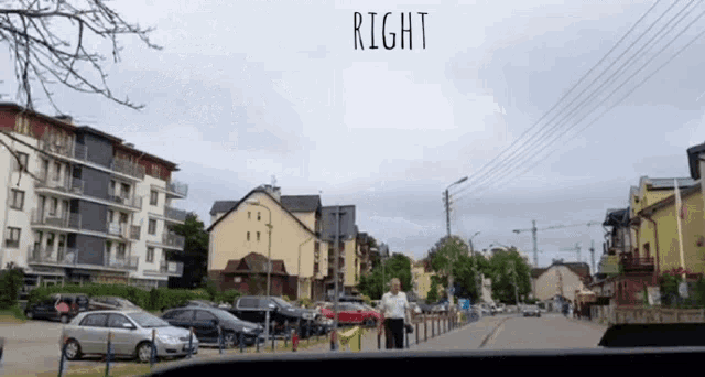a man in a wheelchair walks down a street with the word right above him