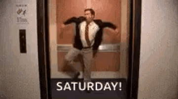 a man in a suit and tie is dancing in an elevator with the words `` saturday ! '' above him .