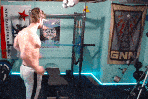 a man is lifting a barbell in a gym with a new california republic flag behind him