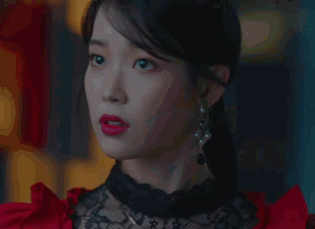 a close up of a woman 's face with a surprised expression