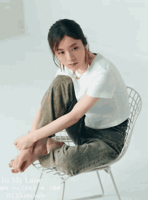 a woman sits in a chair with her legs crossed and the words in my lane written on the bottom