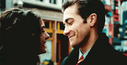 a man and a woman are looking into each other 's eyes .