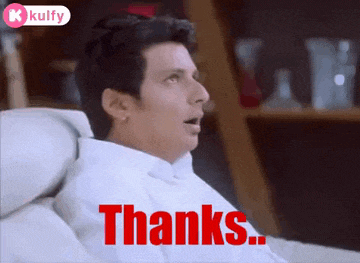 a man in a white shirt is sitting on a couch and saying thanks ..