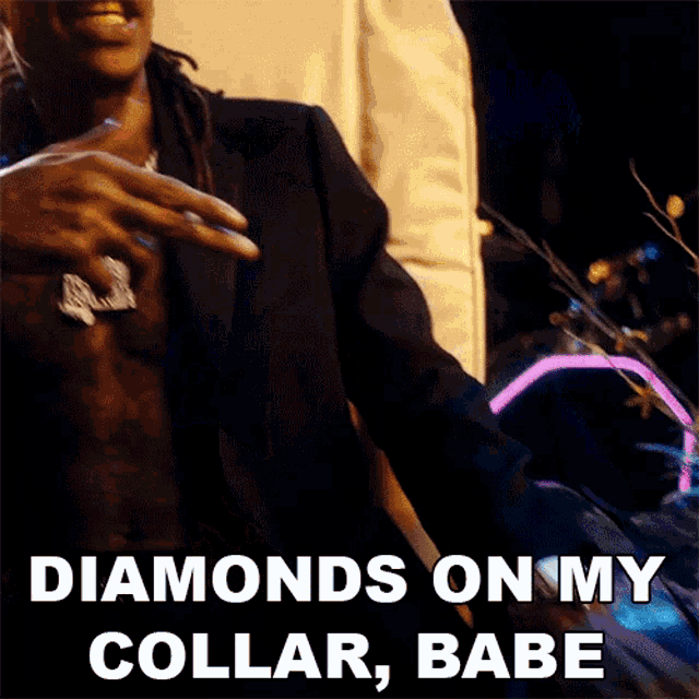 a man in a suit has diamonds on his collar and babe written on the bottom