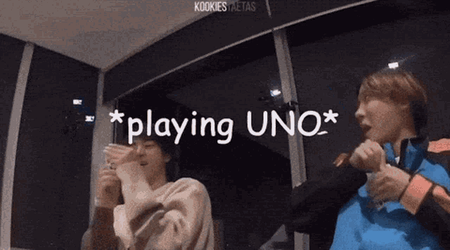 a couple of people are playing a game of uno .