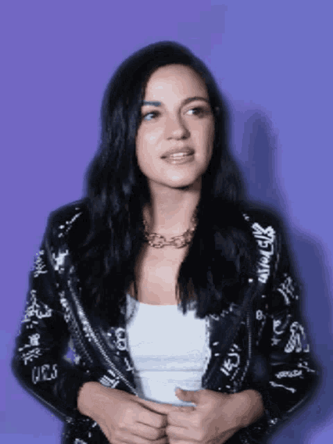 a woman wearing a black jacket that says girls