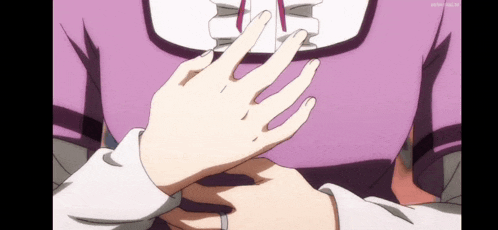 a person holding another person 's hand with a wedding ring on it