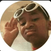 a young boy wearing sunglasses and giving the middle finger .