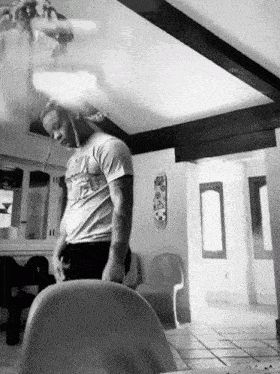 a black and white photo of a man wearing a t-shirt that says ' chicago ' on it