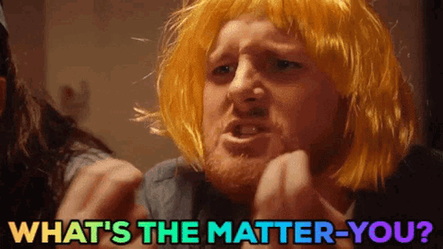 a man wearing a yellow wig is asking what 's the matter-you
