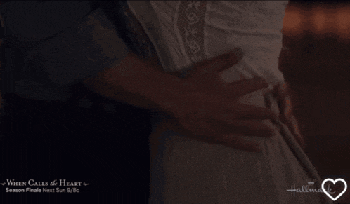 a hallmark ad for when calls the heart shows a man and woman hugging