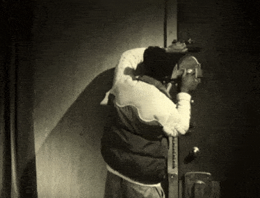 a man in a black and white jacket is talking on the phone