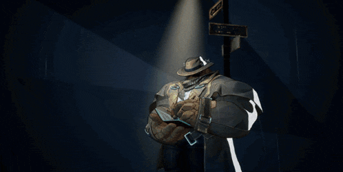 a man with a hat and scarf around his neck holds a gun