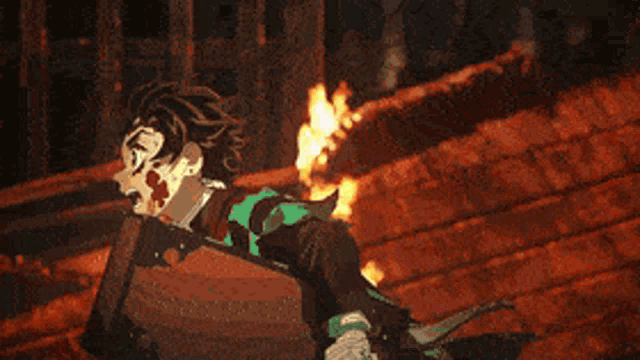 a person is running in front of a burning building .