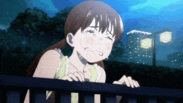 a girl is crying and looking over a railing