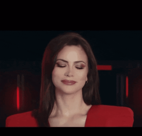 a woman in a red dress is making a silly face