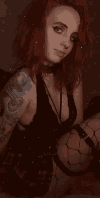 a woman with red hair is wearing fishnet stockings
