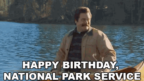 a man in a canoe is saying happy birthday national park service