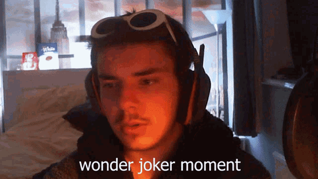 a man wearing headphones and goggles with the words wonder joker moment below him